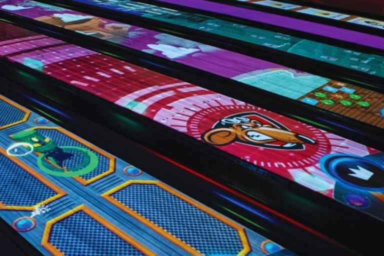 Spark immersive bowling lanes with colorful projected graphics at Cal Bowl